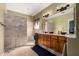 Bright bathroom featuring a tiled walk-in shower, double vanity, and ample lighting at 9938 E Little Nugget Way, Gold Canyon, AZ 85118