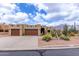 Charming Santa Fe home boasts a desert landscaped yard and two-car garage at 9938 E Little Nugget Way, Gold Canyon, AZ 85118