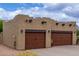 Tuscan-style home features desert landscaping and spacious two-car garage at 9938 E Little Nugget Way, Gold Canyon, AZ 85118