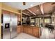 View of kitchen featuring wood cabinets, stainless steel fridge, and adjoining dining area at 9938 E Little Nugget Way, Gold Canyon, AZ 85118