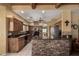 Well-equipped kitchen featuring dark appliances, and an island with stone accenting at 9938 E Little Nugget Way, Gold Canyon, AZ 85118