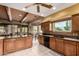 Spacious kitchen featuring wooden cabinets, tile flooring, and a bright eating area at 9938 E Little Nugget Way, Gold Canyon, AZ 85118