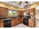 Kitchen showcasing a window, stainless steel microwave, and a black gas range at 9938 E Little Nugget Way, Gold Canyon, AZ 85118