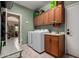 Bright laundry room equipped with sink, washer, and dryer, and ample cabinet space for storage at 9938 E Little Nugget Way, Gold Canyon, AZ 85118