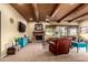Spacious living room featuring wood beams, a brick fireplace, and ample seating at 9938 E Little Nugget Way, Gold Canyon, AZ 85118