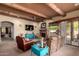 Open-concept living room with wood beams, fireplace, and access to the outdoor space at 9938 E Little Nugget Way, Gold Canyon, AZ 85118