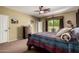 Bedroom features a ceiling fan, carpet, and access to the backyard and pool area at 9938 E Little Nugget Way, Gold Canyon, AZ 85118