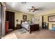 Bedroom features a ceiling fan, carpet, and ample closet space at 9938 E Little Nugget Way, Gold Canyon, AZ 85118
