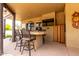 Covered patio area features a built-in bar with ample seating, ideal for entertaining guests outdoors at 9938 E Little Nugget Way, Gold Canyon, AZ 85118