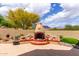 Charming backyard patio features a unique fireplace with detailed stonework, perfect for outdoor relaxation and entertaining at 9938 E Little Nugget Way, Gold Canyon, AZ 85118