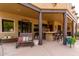Comfortable covered patio with a seating area and outdoor bar, perfect for relaxing and socializing at 9938 E Little Nugget Way, Gold Canyon, AZ 85118