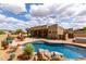 Backyard with a pool and patio surrounded by desert landscaping, ideal for outdoor enjoyment and relaxation at 9938 E Little Nugget Way, Gold Canyon, AZ 85118