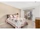 Tranquil bedroom with a queen-size bed and a sliding glass door to the backyard at 10040 W Royal Oak Rd # N, Sun City, AZ 85351