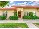 Inviting single-story home with desert landscaping and a red front door at 10040 W Royal Oak Rd # N, Sun City, AZ 85351