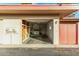 Open garage revealing storage shelves, a laundry area, and a door leading to the house at 10040 W Royal Oak Rd # N, Sun City, AZ 85351