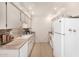 Efficient kitchen with white cabinetry, updated backsplash, and modern appliances at 10040 W Royal Oak Rd # N, Sun City, AZ 85351