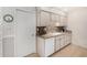 Cozy kitchen featuring white cabinetry, tile backsplash, and modern appliances at 10040 W Royal Oak Rd # N, Sun City, AZ 85351