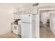 Efficient kitchen layout with white appliances and a seamless transition to the living area at 10040 W Royal Oak Rd # N, Sun City, AZ 85351
