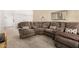 Comfortable living room with a large sectional couch and neutral decor at 10040 W Royal Oak Rd # N, Sun City, AZ 85351