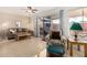 Bright living area featuring tile floors, neutral sofa, and sliding door access to the patio at 10040 W Royal Oak Rd # N, Sun City, AZ 85351