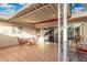 Covered patio with tile flooring, seating, and sliding glass doors provides a relaxing outdoor space at 10040 W Royal Oak Rd # N, Sun City, AZ 85351