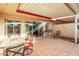 Spacious covered patio featuring tiled flooring, outdoor seating, and access to the home's interior at 10040 W Royal Oak Rd # N, Sun City, AZ 85351
