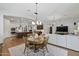 Charming dining room adjacent to the kitchen with a round table and views of the living area at 10154 E Bergeron Ave, Mesa, AZ 85212