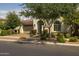 Charming single-story home with a terracotta tile roof, arched entryway, and manicured landscaping at 10154 E Bergeron Ave, Mesa, AZ 85212
