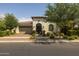Charming single-story home with a terracotta tile roof, arched entryway, and manicured landscaping at 10154 E Bergeron Ave, Mesa, AZ 85212