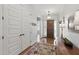 Elegant foyer featuring hardwood floors, a chandelier, and a solid wood front door at 10154 E Bergeron Ave, Mesa, AZ 85212