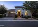 Charming single-story home showcasing a beautiful front yard, well-manicured landscaping, and a two-car garage at 10154 E Bergeron Ave, Mesa, AZ 85212