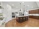 Well-lit kitchen featuring a large island with seating and modern appliances, perfect for entertaining at 10154 E Bergeron Ave, Mesa, AZ 85212