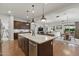 Open concept kitchen with island, granite countertops, and a view of the living and dining areas at 10154 E Bergeron Ave, Mesa, AZ 85212