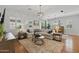 Bright living room featuring hardwood floors, neutral furniture, and large windows with plantation shutters at 10154 E Bergeron Ave, Mesa, AZ 85212