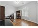 Home office with built-in bookshelves, desk, and plenty of natural light from a large window at 10154 E Bergeron Ave, Mesa, AZ 85212