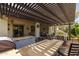 Extensive outdoor living area with a grill, dining space, pergola, and comfortable seating for relaxation at 10154 E Bergeron Ave, Mesa, AZ 85212