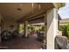 Covered outdoor patio with brick flooring, comfortable seating, and a built-in bar area at 10154 E Bergeron Ave, Mesa, AZ 85212