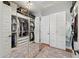 Large walk-in closet with ample storage space, mirrored doors, and custom shelving and a view into the laundry room at 10154 E Bergeron Ave, Mesa, AZ 85212