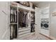 Organized walk-in closet with custom shelving and drawers, connecting to a laundry room at 10154 E Bergeron Ave, Mesa, AZ 85212