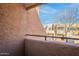 Cozy balcony space with views of surrounding neighborhood and trees at 11640 N 51St Ave # 248, Glendale, AZ 85304