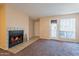 Inviting living room showcasing a fireplace and access to the outdoor patio at 11640 N 51St Ave # 248, Glendale, AZ 85304