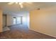 Open-concept living area with neutral decor, ceiling fan, and patio access at 11640 N 51St Ave # 248, Glendale, AZ 85304