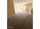 Bright living room with new carpeting, neutral paint, and access to a private balcony at 11640 N 51St Ave # 248, Glendale, AZ 85304