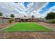 Backyard features a manicured lawn, patio, and lush landscaping at 1210 W Missouri Ave, Phoenix, AZ 85013
