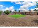 Expansive backyard boasts a green lawn, charming patio, brick home and a cozy firepit, ideal for entertaining at 1210 W Missouri Ave, Phoenix, AZ 85013