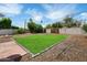 Spacious backyard featuring lush green lawn, a cozy firepit and privacy fencing for outdoor enjoyment at 1210 W Missouri Ave, Phoenix, AZ 85013