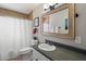 Bathroom featuring a mirror, vanity, and a bathtub with a shower at 1210 W Missouri Ave, Phoenix, AZ 85013