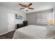 Bedroom with a ceiling fan, television and a window with blinds at 1210 W Missouri Ave, Phoenix, AZ 85013