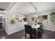 Bright dining area adjacent to the kitchen, featuring modern lighting and a view of the outdoor greenery at 1210 W Missouri Ave, Phoenix, AZ 85013