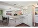 Bright kitchen featuring grey cabinets, granite countertops, and an open design to the adjacent dining area at 1210 W Missouri Ave, Phoenix, AZ 85013